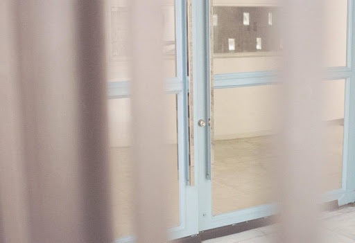 Clear PVC strip curtain panels hanging across an open doorway